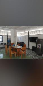 a living room with a table and some chairs at Sandy Homestay-Vĩnh Hy in Ninh Hải