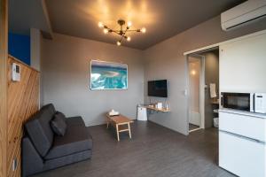 a living room with a couch and a microwave at Coteji Do - Vacation STAY 92057v in Ishigaki Island
