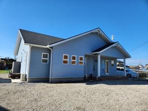 a blue house with a car parked in front of it at Sakuda Bliss - Vacation STAY 93274v in Katakai
