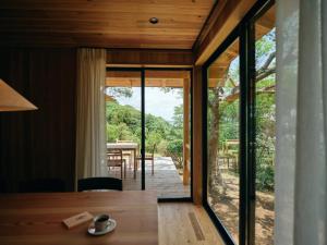 a dining room with glass doors and a table at Suikyoen - Vacation STAY 16642v in Kasumigaura
