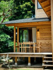 a cabin with a table and chairs on the porch at Suigoen - Vacation STAY 60308v in Kasumigaura