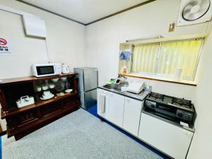 a small kitchen with a stove and a refrigerator at Kamizawa Villa - Vacation STAY 16914 in Hokota +18 photos