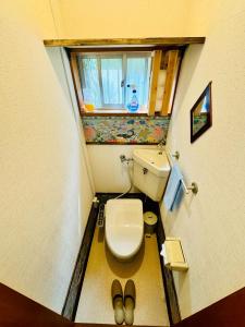a small bathroom with a toilet and a window at Kamizawa Villa - Vacation STAY 16914 in Hokota