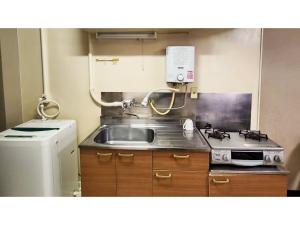 a kitchen with a sink and a stove at Mamada Building - Vacation STAY 18001 in Tokyo