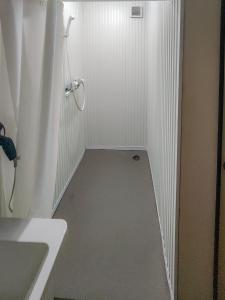 a small white bathroom with a shower and a sink at Mamada Building - Vacation STAY 18229 in Tokyo