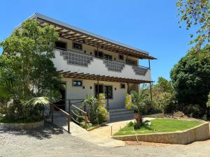 a white house with a staircase in front of it at Virgin River Resort Villas in Bolinao