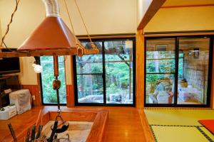 a kitchen with large windows and aendant light at Hitensanso - Vacation STAY 99438v in Azumino