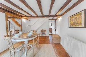 a dining room with a table and chairs at Dolphin Cottage in Henley on Thames