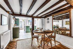 a dining room with a table and chairs at Dolphin Cottage in Henley on Thames