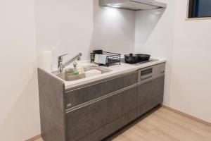 a kitchen with a sink and a counter at Yufunoshizuku -Asagiri-Yunagi-Akatsuki- - Vacation STAY 01489v in Yufuin +28 photos