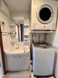 a small bathroom with a sink and a microwave at Kin-Con-Kan - Vacation STAY 05378v in Nanjo