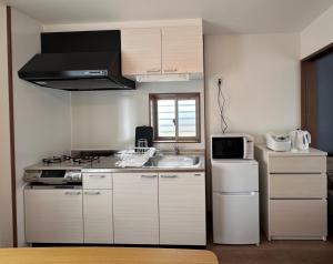 a kitchen with a sink and a stove top oven at Kin-Con-Kan - Vacation STAY 03032v in Nanjo +15 photos