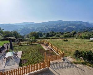 a wooden fence with a view of a field at Casa Verana en Asturias VV-3421-AS in Granda