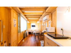 a kitchen and living room with a table and chairs at Mobilita Court Iwate - Vacation STAY 13604v in Hachimantai