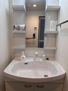 a person taking a picture of a bathroom sink at Kin-Con-Kan - Vacation STAY 05400v in Nanjo +23 photos