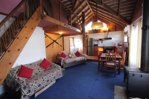 a living room with a couch and a dining room at Pichipehuen in Malalcahuello