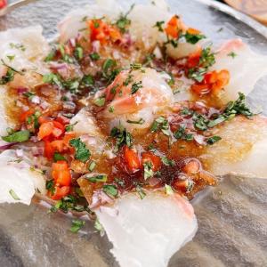 a close up of a plate of food with vegetables on it at Bonfire Beach Club - Vacation STAY 06134v in Katakai