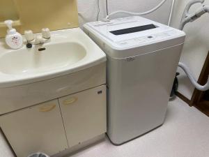 a bathroom with a sink and a small refrigerator at Rakuten Stay [Homelike Makuhari Hongo] - Vacation STAY 16003v in Chiba +18 photos