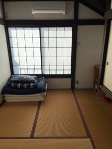 a room with a bed and two large windows at Rakuten Stay [Homelike Makuhari Hongo] - Vacation STAY 16003v in Chiba