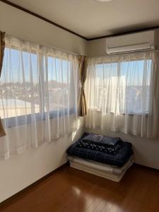 a room with a bed in front of a window at Rakuten Stay [Homelike Makuhari Hongo] - Vacation STAY 16003v in Chiba