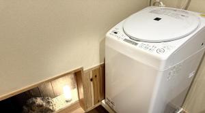 a washing machine in a room with a candle at Villa East West - Vacation STAY 18083v in Nara