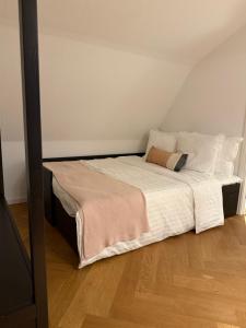 a bed with white sheets and pillows in a room at Het Heerenhuys in Alkmaar +16 photos