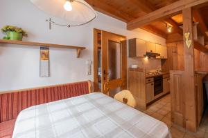 a kitchen with a bed in a room at Haus 76 Top 1 in Krimml