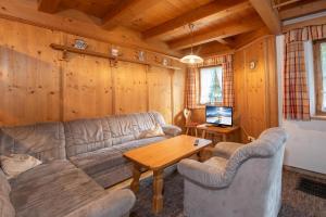 a living room with a couch and a table at Haus 76 Top 1 in Krimml