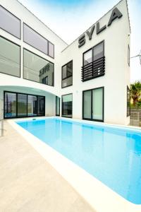 an exterior view of a house with a swimming pool at Syla Hotel ZUSHI-HAYAMA THE Pool Villa - Vacation STAY 17108 in Yokosuka