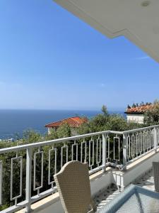 a balcony with chairs and the ocean in the background at Dhermi Village Apartments in Dhërmi