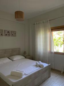 a bedroom with a bed with two towels on it at Dhermi Village Apartments in Dhërmi
