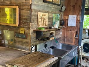 a kitchen with a sink and a wooden wall at Playhouse Conifer - Vacation STAY 24024v in Mikage