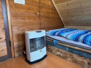 a small room with a heater in a cabin at Playhouse Conifer - Vacation STAY 24024v in Mikage