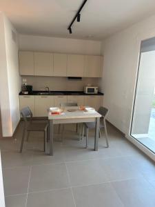 a kitchen with a table and chairs in a room at SELICE 42 RESIDENCE Imola in Imola
