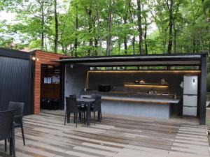 a patio with a bar and a table and chairs at Mori de Waoke Nasuppo - Vacation STAY 23918v in Nasu-yumoto
