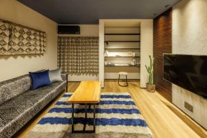 a living room with a couch and a coffee table at villa-rizo midorigaoka - Vacation STAY 17519 in Takayama