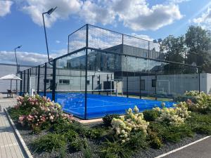 a glass building with a swimming pool in front of it at Sport & Relax Hotel Davidek in Trutnov