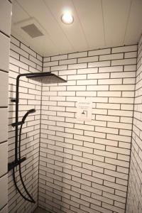 a white tiled shower with a hose in a bathroom at Roots Inawashiro Lake Area - Vacation STAY 29941v in Inawashiro