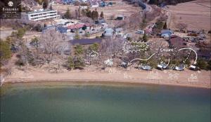 an aerial view of a beach with a body of water at Roots Inawashiro Lake Area - Vacation STAY 29938v in Inawashiro