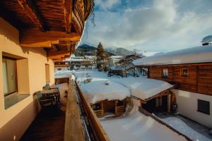 a balcony of a house covered in snow at Appartement SEPPI by MoniCare (Haus Claudia) in Seefeld in Tirol