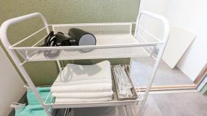 a white towel rack with towels on it at Waka no Yado -Oto- - Vacation STAY 17181 in Wakayama