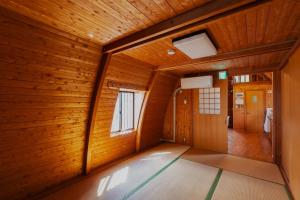 an empty room with wood walls and a hallway at ARCH HOUSE TAKASHIMA - Vacation STAY 31925v in Takashima