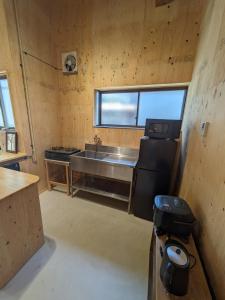 eine Küche mit Spüle und Herd im Zimmer in der Unterkunft HANARE STAY&SPACE - Vacation STAY 38426v in Misaki