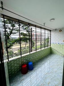 a room with large windows with twoools in front of it at Saudia Residential Hotel in Boāli