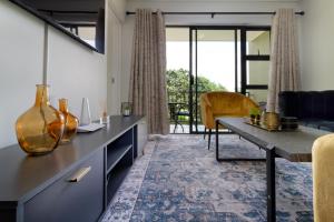 a living room with a table and a couch at #AlimamaSpaces Jade's Greenlee in Sandton