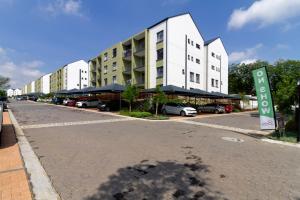 an empty street in front of a building at #AlimamaSpaces Jade's Greenlee in Sandton