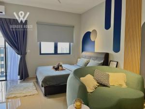 a bedroom with a bed and a couch in it at Modern Stay at Seri Kembangan - 20 mins to Pavilion Bukit Jalil in Seri Kembangan