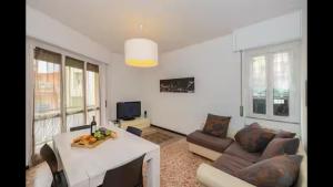 a living room with a table and a couch at Ca' di GiuPa Finalborgo Outdoor in Finale Ligure