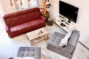an overhead view of a living room with a red couch at Luxury Villa Marija Panoramic Pool & Nature Retreat in Podgorica