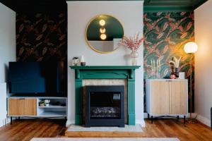 a living room with a fireplace and a mirror at Above Rubies- Bowling Terrace, Dog Friendly, Walks in Skipton +57 photos